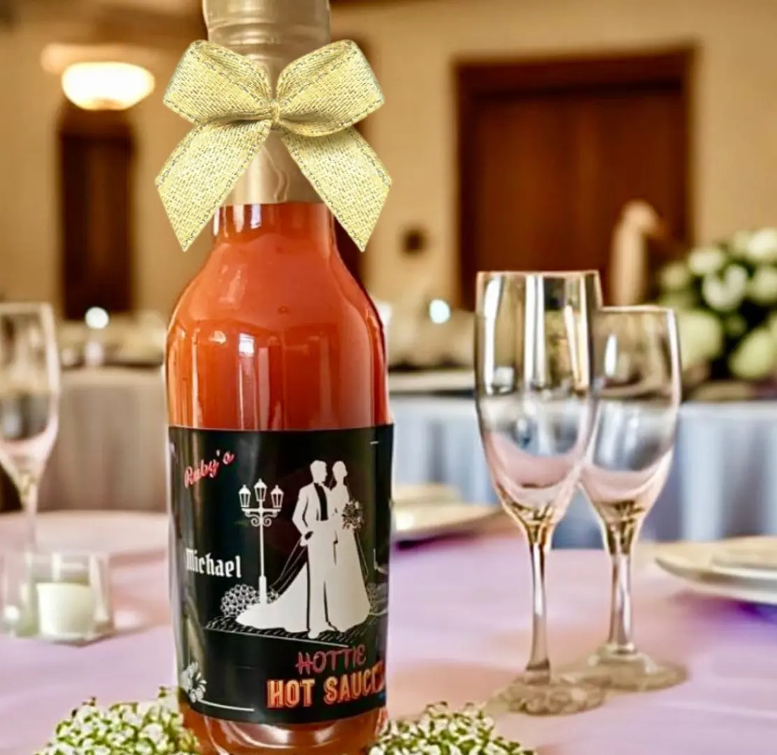 A bottle of hot sauce on top of a table.